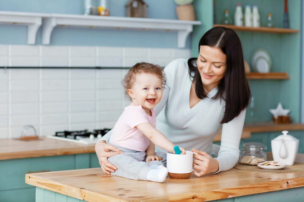 A smiling baby with their babysitter playing at home in Budapest